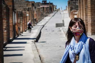 People visit the ancient city of Pompei, located in the zone of Pompei Scavi, in Pompei, near Naples, which reopened to the public today, Italy, 26 May 2020. Today has begun the first phase of two weeks that will allow a walk along the streets of the ancient city, and admire the most representative places of the site according to a pre-established route, on time slots, and with the necessary distancing measures provided by the Ministry of Health. Already in this first phase it will be possible to access some houses with large spaces, and to discover some novelties in preview, such as the Domus of Cornelio Rufo with its colonnaded garden which incorporates the flourishing garden, recently restored. From June 9, a second band will follow with the opening of further unpublished spaces and domus, with separate entrance and exit, and with the support of technology to organize and monitor flows. ANSA/CESARE ABBATE