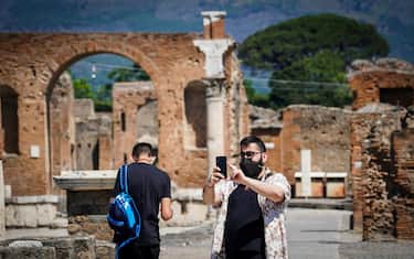 People visit the ancient city of Pompei, located in the zone of Pompei Scavi, in Pompei, near Naples, which reopened to the public today, Italy, 26 May 2020. Today has begun the first phase of two weeks that will allow a walk along the streets of the ancient city, and admire the most representative places of the site according to a pre-established route, on time slots, and with the necessary distancing measures provided by the Ministry of Health. Already in this first phase it will be possible to access some houses with large spaces, and to discover some novelties in preview, such as the Domus of Cornelio Rufo with its colonnaded garden which incorporates the flourishing garden, recently restored. From June 9, a second band will follow with the opening of further unpublished spaces and domus, with separate entrance and exit, and with the support of technology to organize and monitor flows. ANSA/CESARE ABBATE