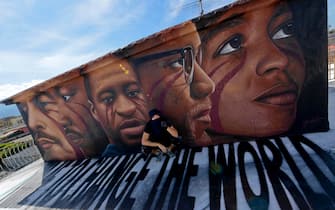 Italian street artist Jorit Agoch poses next to his latest work, a huge mural in memory of George Floyd, in Naples, southern Italy, 04 June 2020. Faces of Lenin, Martin Luther King, Malcom X and Angela Davis are also painted on the mural.
ANSA/ CIRO FUSCO