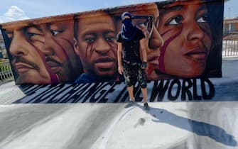 Italian street artist Jorit Agoch poses next to his latest work, a huge mural in memory of George Floyd, in Naples, southern Italy, 04 June 2020. Faces of Lenin, Martin Luther King, Malcom X and Angela Davis are also painted on the mural.
ANSA/ CIRO FUSCO