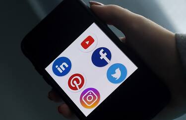 This illustration picture shows social media applications logos from Linkedin, YouTube, Pinterest, Facebook, Instagram and Twitter displayed on a smartphone in Arlington, Virginia on May 28, 2020. - Trump is expected to sign an executive order on May 28, 2020, after threatening to shutter social media platforms following Twitter's move to label two of his tweets misleading. (Photo by Olivier DOULIERY / AFP)