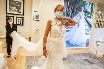 BARCELONA, SPAIN - JUNE 10: Sara Aragones wearing a protective face mask attends a wedding dress rehearsal at Pronovias store on June 10, 2020 in Barcelona, Spain. Spain has largely ended the lockdown it imposed to curb the spread of Covid-19, which caused the death of more than 27,000 people across the country. This week all regions are on Phase One or Two, one month after all of Spain started on Phase zero on May 4, 2020. (Photo by David Ramos/Getty Images)