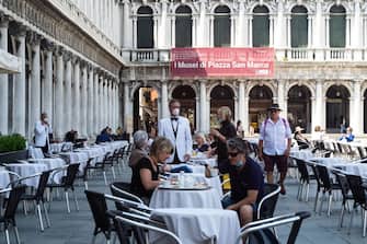 1249199398 VENICE, ITALY - JUNE 12: Customers enjoy the reopening of the Florian Cafè after 3 months of closure due to Covid-19 on June 12, 2020 in Venice, Italy. The whole country is returning to normality after more than two months of a nationwide lockdown meant to curb the spread of Covid-19. (Photo by Simone Padovani/Awakening/Getty Images)