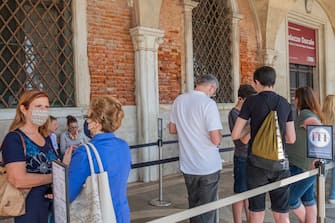 VENICE, ITALY - JUNE 13: Tourists are waiting to enter the Doge's Palace, which reopened today on June 13, 2020 in Venice, Italy. The whole country is returning to normality after more than two months of a nationwide lockdown meant to curb the spread of Covid-19. (Photo by Stefano Mazzola/Awakening/Getty Images)