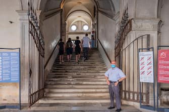 1249367537 VENICE, ITALY - JUNE 13: Tourists enter the Doge's Palace, which reopened today on June 13, 2020 in Venice, Italy. The whole country is returning to normality after more than two months of a nationwide lockdown meant to curb the spread of Covid-19. (Photo by Stefano Mazzola/Awakening/Getty Images)
