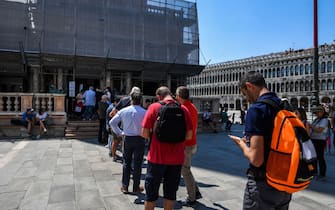 People line up to visit the Bell Tower at St. Marks's Square on June 12, 2020 in Venice as the country eases its lockdown aimed at curbing the spread of the COVID-19 infection, caused by the novel coronavirus. (Photo by ANDREA PATTARO / AFP) (Photo by ANDREA PATTARO/AFP via Getty Images)