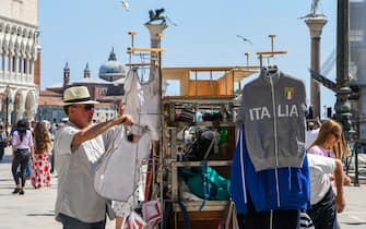 A street seller sets his cart at St. Marks's Square on June 12, 2020 in Venice as the country eases its lockdown aimed at curbing the spread of the COVID-19 infection, caused by the novel coronavirus. (Photo by ANDREA PATTARO / AFP) (Photo by ANDREA PATTARO/AFP via Getty Images)