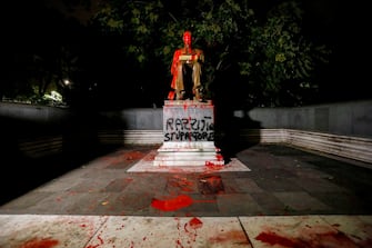 A statue dedicated to Italian journalist Indro Montanelli is smeared with red paint, with the words 'Racist, rapist' written on the base, at the homonymous garden in via Palestro in the center of Milan, Italy, 13 June 2020. 
ANSA/Mourad Balti Touati
