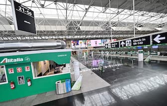 1207452113 A general view shows Alitalia check-in counters in a deserted Terminal T1 at Rome's Fiumicino international airport on March 17, 2020. - Rome's second airport, Ciampino, has been closed, while Fiumicino is to close the T1, one of its three terminals from March 17. (Photo by ANDREAS SOLARO / AFP) (Photo by ANDREAS SOLARO/AFP via Getty Images)