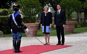 Italian Prime Minister Matteo Renzi and his British counterpart Theresa May stand during a welcome ceremony for Britain's Prime Minister in the garden of Villa Doria Pamphili prior to a meeting in Rome on July 27, 2016. / AFP / TIZIANA FABI        (Photo credit should read TIZIANA FABI/AFP via Getty Images)