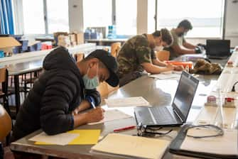 IRUN, SPAIN - MAY 25: Students wearing face masks work during a technology subject class at the BIDASOA Vocational School on May 25, 2020 in Irun, Spain. Some parts of Spain have entered the so-called "Phase One" or "Phase Two" transitions from its coronavirus lockdown, allowing many shops to reopen as well as restaurants who serve customers outdoors. Locations that were harder hit by coronavirus (Covid-19), such as Madrid and Barcelona, remain in a stricter quarantine. (Photo by Gari Garaialde/Getty Images)