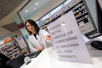 An employee shows a sign informing customers that the Amuchina disinfectant and protective face masks are sold out, Palermo, Italy, 25 February 2020.  ANSA / Igor Petyx