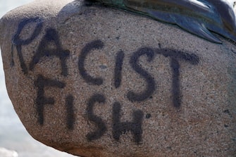 A picture taken on July 3, 2020 shows a graffiti on the rock below the "Little Mermaid" sculpture after it has been vandalised in Copenhagen. (Photo by Mads Claus Rasmussen / Ritzau Scanpix / AFP) / Denmark OUT (Photo by MADS CLAUS RASMUSSEN/Ritzau Scanpix/AFP via Getty Images)