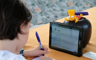 MILAN, ITALY - MAY 06: Fourth grade student Nicolo, 10, son of the photographer, uses a tablet to participate in an E-learning class with his teacher and classmates while at home on May 06, 2020 in Milan, Italy. Italy will remain on lockdown to stem the transmission of the Coronavirus (Covid-19), slowly easing restrictions.  (Photo by Pier Marco Tacca/Getty Images)