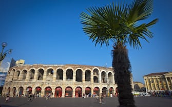 VERONA, ITALY - JULY 14: (EDITORS NOTE: Exposure latitude of this composite image has been digitally increased) Piazza Bra and the Arena of Verona with a palm tree on July 14, 2010 in Verona, Italy. The famous Arena di Verona is popular for the annual opera festival in summer. The arena is one of the largest ancient roman amphitheatres. It was built in 30 A.C. and belongs to the Unesco World Heritage.  (Photo by EyesWideOpen/Getty Images)