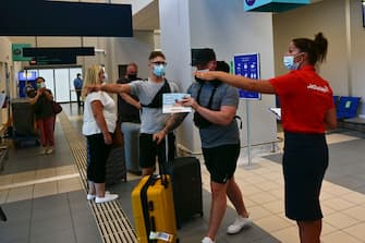 ZAKYNTHOS, GREECE - JULY 15: Passengers of a flight from United Kingdom wearing protective face masks arrive at the Zakinthos Airport on Zakinthos Island on July 15, 2020 in Zakynthos, Greece. (Photo by Milos Bicanski/Getty Images)