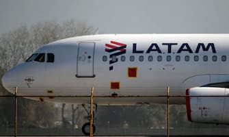 A Latam airlines plane sits on the tarmac at Santiago International Airport, in Santiago on May 26,2020, during the new coronavirus, COVID-19, pandemic. - Latin America's biggest airline, the Brazilian-Chilean group LATAM, filed for bankruptcy in the US, according to a statement on May 25, 2020. Shares in Latin America's largest airline plunged 35 percent on the Santiago stock exchange following  the filing for bankruptcy. (Photo by MARTIN BERNETTI / AFP) (Photo by MARTIN BERNETTI/AFP via Getty Images)