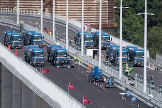 Trucks drive over the new Genoa bridge as static testing of the bridge has started, in Genoa, Italy, 19 July 2020. Eight trucks are moving on the new viaduct on the Polcevera river. The trucks entered the bridge on the east side, on the southbound carriageway, and then turned back, to continue with some maneuvers on the new structure. The new bridge is under construction after the Morandi highway bridge partially collapsed on 14 August 2018, killing a total of 43 people. 
ANSA/LUCA ZENNARO

