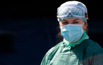 A medical worker wearing a face mask is pictured on May 6, 2020 at the Tor Vergata Covid hospital in Rome, during the country's lockdown aimed at curbing the spread of the COVID-19 infection, caused by the novel coronavirus. (Photo by Tiziana FABI / AFP) (Photo by TIZIANA FABI/AFP via Getty Images)