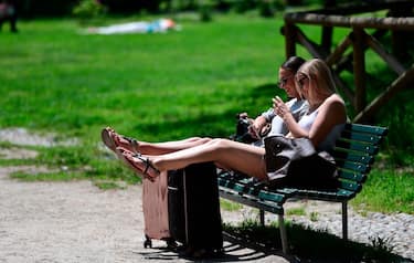 People enjoy the warm weather in Sempione garden, central Milan on Mai 23, 2019. (Photo by Miguel MEDINA / AFP)        (Photo credit should read MIGUEL MEDINA/AFP via Getty Images)