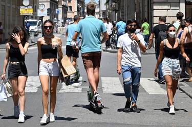 Young men (C) ride shared electric scooters on June 22, 2020 across the pedestrian part of the Via del Corso main shopping street in Rome, as the country eases its lockdown aimed at curbing the spread of the COVID-19 infection, caused by the novel coronavirus. - With deconfinement and good weather, self-service shared electric scooters have invaded the streets of Rome in recent days, a novelty in the Eternal City, which in turn is discovering the joys and nuisances of new forms of mobility. (Photo by Alberto PIZZOLI / AFP) (Photo by ALBERTO PIZZOLI/AFP via Getty Images)