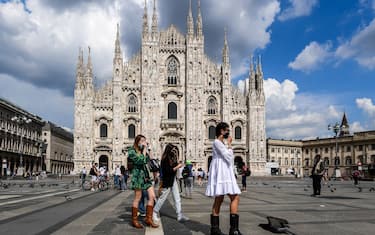 Young woman walk across Piazza del Duomo and the cathedral on June 3, 2020 in downtown Milan, as the country eases its lockdown aimed at curbing the spread of the COVID-19 infection, caused by the novel coronavirus. (Photo by Miguel MEDINA / AFP) (Photo by MIGUEL MEDINA/AFP via Getty Images)