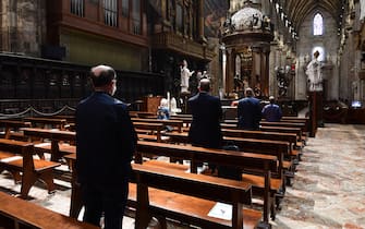 People attend a mass at the Cappella Feriale chapel of the Duomo cathedral in Milan on May 18, 2020 during the country's lockdown aimed at curbing the spread of the COVID-19 infection, caused by the novel coronavirus. - Restaurants and churches reopen in Italy on May 18, 2020 as part of a fresh wave of lockdown easing in Europe and the country's latest step in a cautious, gradual return to normality, allowing businesses and churches to reopen after a two-month lockdown. (Photo by Miguel MEDINA / AFP) (Photo by MIGUEL MEDINA/AFP via Getty Images)