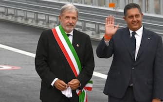 Genoa Mayor Marco Bucci (L) and Giovanni Toti, president of Liguria region take part in the inauguration ceremony of the new San Giorgio bridge on August 3, 2020 in Genoa. - The new high-tech structure will have four maintenance robots running along its length to spot weathering or erosion, as well as a special dehumidification system to limit corrosion. Italy inaugurates a sleek new bridge in Genoa, though relatives of the 43 people killed when the old viaduct collapsed say the pomp and ceremony risk overshadowing the tragedy. (Photo by Andreas SOLARO / AFP) (Photo by ANDREAS SOLARO/AFP via Getty Images)