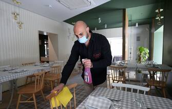 SALERNO, ITALY - MAY 21: Donato Luongo, owner of Trattoria Da SasÃ , taking measures for social distancing in his restaurant on May 21, 2020 in Salerno, Italy. Restaurants, bars, cafes, hairdressers and other shops have reopened, subject to social distancing measures, after more than two months of a nationwide lockdown meant to curb the spread of Covid-19