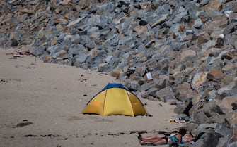 This picture shows a tourist near camping cars on the beach of Gouville-sur-Mer on August 03, 2020. (Photo by JOEL SAGET / AFP) (Photo by JOEL SAGET/AFP via Getty Images)