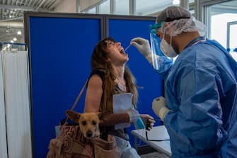 ATHENS, GREECE - JUNE 15: Medical staff conduct a test for the new coronavirus on the passengers who arrived from Rome to Eleftherios Venizelos International Airport on June 15, 2020 in Athens, Greece. The country removed most restrictions on travel from EU countries today in an effort to jumpstart its tourist season. Travelers from countries deemed high-risk, like the UK countries, will still face compulsory Covid-19 testing and mandatory quarantine. One week for a negative result; two weeks for a positive result. (Photo by Milos Bicanski/Getty Images)