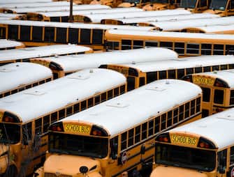 About 100 school buses are parked at the Arlington County Bus Depot,  in response to the novel coronavirus, COVID-19 outbreak on March 31, 2020 in Arlington, Virginia. - Forty-seven states and the District of Columbia have decided to close schools in response to the coronavirus pandemic, affecting nearly 55 million students and seven US states have closed school for the remainder of the year, as the coronavirus outbreak continues to spread across the country. (Photo by Olivier DOULIERY / AFP) (Photo by OLIVIER DOULIERY/AFP via Getty Images)