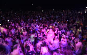 Thousands of partygoers dance on the beach during the Full Moon Party on Ko Phangan island in the southern Thai province of Surat Thani on the night of December 14, 2016.
Foreign tourists are returning in droves to the popular party island of Ko Phangan for the infamous Full Moon Party after restrictions on celebrations were eased months after the death of Thai King Bhumibol Adulyadej on October 13. / AFP / LILLIAN SUWANRUMPHA        (Photo credit should read LILLIAN SUWANRUMPHA/AFP via Getty Images)