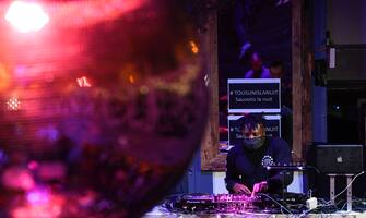 A Dj wearing a face mask performs at the Balrock bar in Paris, on July 1, 2020, during an event to protest the continued closure of nightclubs and cancellation of Summer festivals imposed as part of lockdown measures to curb the spread of the COVID-19 (novel coronavirus) pandemic, while many sectors in France have seen their restrictions progressively lifted. (Photo by ALAIN JOCARD / AFP) (Photo by ALAIN JOCARD/AFP via Getty Images)