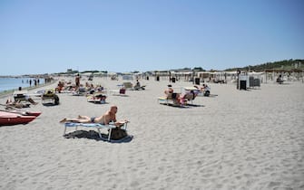 Bathers enjoy a warm and sunny day at Punta Canna beach establishment in Chioggia, near Venice, northern Italy, 10 July 2017. Venice Prefect Carlo Boffi on Monday signed an order for the beach establishment to "immediately remove all references to Fascism on signs, posters and banners". The move comes after reports of images sympathetic to Fascism and Benito Mussolini at Chioggia's Punta Canna establishment caused a furore. ANSA/ ALESSANDRO SCARPA