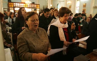 GAZA CITY, GAZA - DECEMBER 16:  The congregation sing a hymn during the Sunday mass prayer service lead by Latin Patriarch of Jerusalem, Archbishop Michel Sabbah, at the Latin Holy Family Church on December 16, 2007 in Gaza City, Gaza Strip. It is the first time that the Vatican ambassador to Israel has entered and lead prayers in Gaza since the Hamas movement took over control of the Gaza Strip on June 14, 2007.  (Photo by Abid Katib/Getty Images)