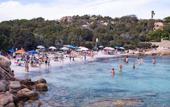 1266987220 PORTO CERVO, ITALY - AUGUST 18: A view of a beach in Porto Cervo full of tourists in this week of August. Many Italians have chosen Italian tourist locations to spend their summer holidays on August 18, 2020 in Porto Cervo, Italy. (Photo by Emanuele Perrone/Getty Images)