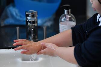 A year two student washes her hands during their first day of school after the summer break at St Luke's Church of England Primary School in East London on September 3, 2020. - Pupils in Britain have on Thursday begun to return to schools for the first time since they were all closed in March, due to the COVID-19 pandemic. (Photo by DANIEL LEAL-OLIVAS / AFP) (Photo by DANIEL LEAL-OLIVAS/AFP via Getty Images)