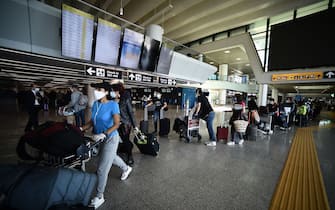 Travelers walk across a terminal at Rome's Fiumicino airport on June 3, 2020, as airports and borders reopen for tourists and residents free to travel across the country, within the COVID-19 infection, caused by the novel coronavirus. (Photo by Filippo MONTEFORTE / AFP) (Photo by FILIPPO MONTEFORTE/AFP via Getty Images)