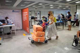 ROME, ITALY - AUGUST 25: Passengers arriving from high-risk countries wait to carry out rapid antigenic tests for Covid-19 at a testing station set up inside Leonardo Da Vinci airport, on August 25, 2020 in Fiumicino, Rome, Italy. The region has introduced mandatory COVID-19 tests for anyone arriving from Croatia, Greece, Spain and Malta to avoid a spike of new cases. (Photo by Antonio Masiello/Getty Images)