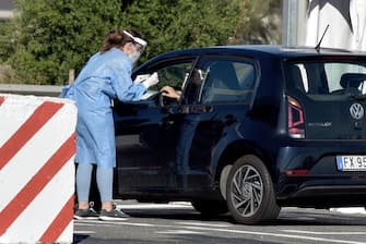 1228337171 ROME, ITALY - SEPTEMBER 04: Medical staff attend the new COVID-19 drive-in test centre, the largest in the Lazio region, to carry out rapid COVID-19 antigen swabs in the Long Stay car park at Leonardo da Vinci-Fiumicino Airport on September 4, 2020 in Rome, Italy. (Photo by Simona Granati - Corbis/Getty Images)
