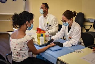 Health workers perfom a fast serological test for coronavirus disease (COVID-19) positivity on teachers and school staffs at the Gaetano Pini hospital in Milan, Italy, 25 August 2020. The start date of the lessons for the school year 2020/2021 has been set for 14 September. ANSA/ MATTEO CORNER