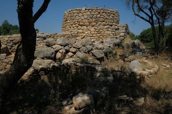 1014449544 ARZACHENA, ITALY - JULY 26: The ancient site of Nuraghe La Prigiona stands on July 26, 2018 on the island of Sardinia near Arzachena, Italy. Sardinia is a popular summer tourist destination. (Photo by Sean Gallup/Getty Images)