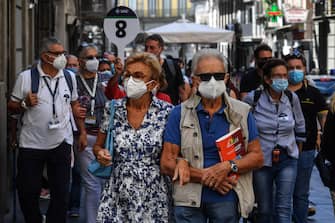 Tourists wear face masks after the southern Italian region of Campania made it mandatory to wear protective face coverings outdoors 24 hours a day, to contain the coronavirus disease (COVID-19) outbreak