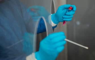 A health worker prepares to collect a swab sample to test a patient for COVID-19 in Nezahualcoyotl, Mexico state on July 13, 2020 amid the coronavirus pandemic. - Mexico became on Sunday the fourth country with the most deaths in the world from the new coronavirus after overtaking Italy, according to an AFP report based on government sources. (Photo by PEDRO PARDO / AFP) (Photo by PEDRO PARDO/AFP via Getty Images)
