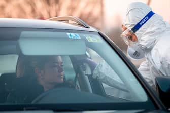 A medical worker measures the body temperature of a motorist  at the Slovenian-Italian border crossing near Nova Gorica, on March 11, 2020, after Slovenia's government announced it would close its border with Italy, hard hit by the outbreak of COVID-19, the new coronavirus. - Italy's neighbours Austria and Slovenia announced on March 10 Tuesday strict travel restrictions and other measures in the wake of similar moves by Rome to limit the spread of the new coronavirus. (Photo by Jure Makovec / AFP) (Photo by JURE MAKOVEC/AFP via Getty Images)