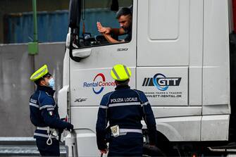Police-men stop a lorry driver outside cityÕs harbour as entries are delayed due to a heavy snowfall, in Genoa, Italy, 28 December 2020ANSA/SIMONE ARVEDA