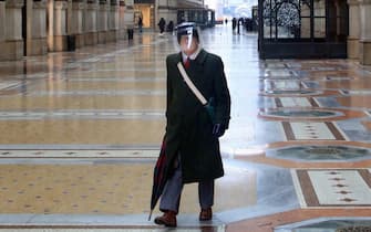 A man walks in the deserted Galleria Vittorio Emanuele wearing a protection against Covid-19, in Milan, Italy, 01 January 2021. Italy marks the New Year in 'red zone' lockdown with a curfew from 10 pm to 7 am and New Year's Eve parties banned, as part of efforts put in place to curb the spread of the coronavirus disease. ANSA / PAOLO SALMOIRAGO