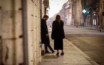 A man and a woman in an via del Corso empty during a complete lockdown for New Year's Eve celebrations as part of efforts put in place to curb the spread of the coronavirus disease, in Rome, Italy, 1 January  2021, ANSA/GIUSEPPE LAMI