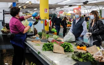 Locals shopping for fresh produce, like fruits, veggies, fishes, meats and cheeses at a food market in San Paolo neighborhood during the coronavirus lockdown in Rome, Italy, 18 April 2020. ANSA/RICCARDO ANTIMIANI